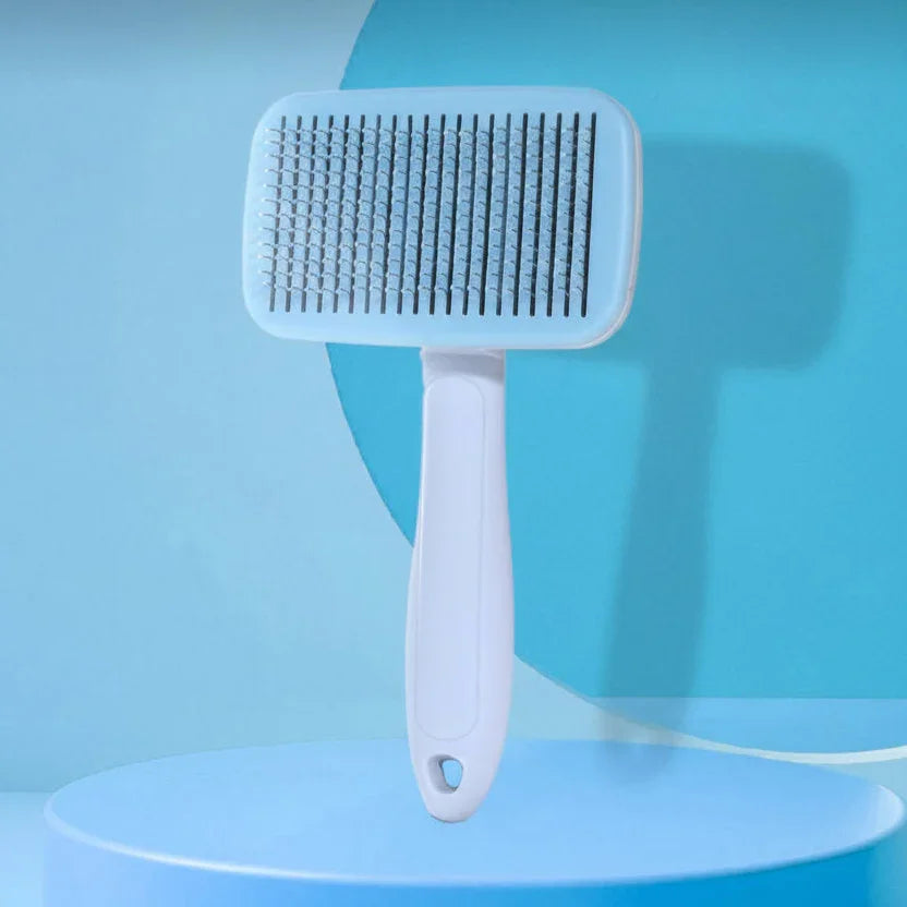 White pet grooming brush with fine bristles on a blue background