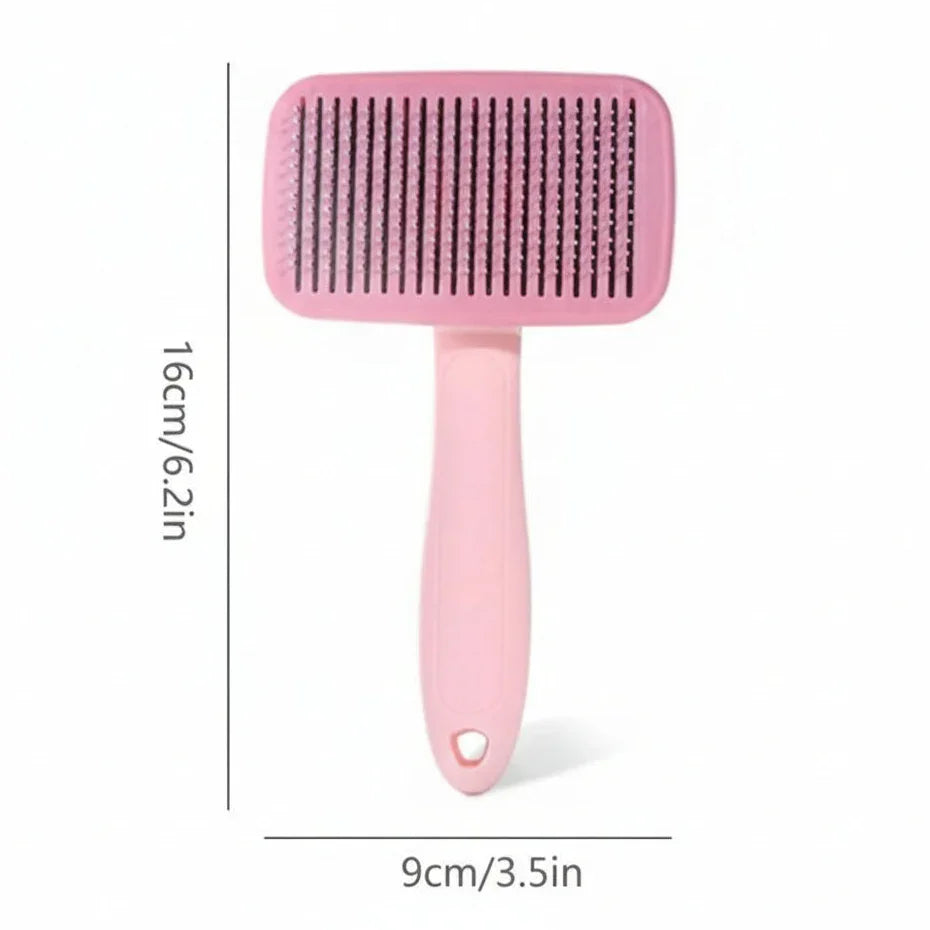 Pink pet grooming brush with handle, 16cm by 9cm, for cats and dogs on white background