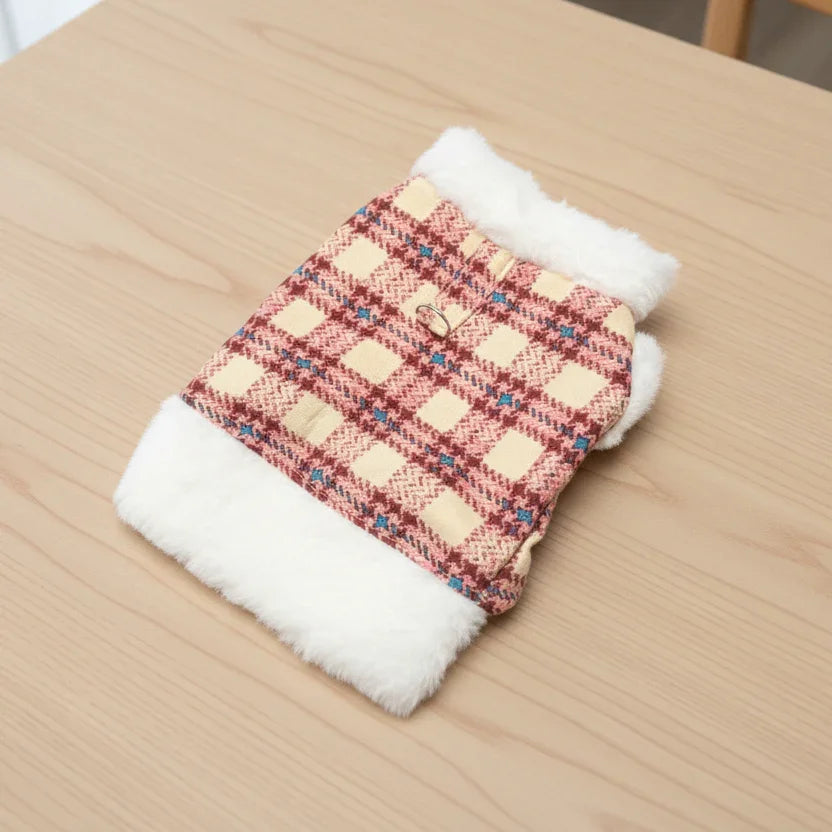 Plaid pet sweater with faux fur trim, cozy dog clothing on a wooden table