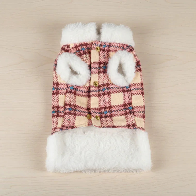 Plaid fleece pet jacket with buttons and white faux fur trim on light wood background