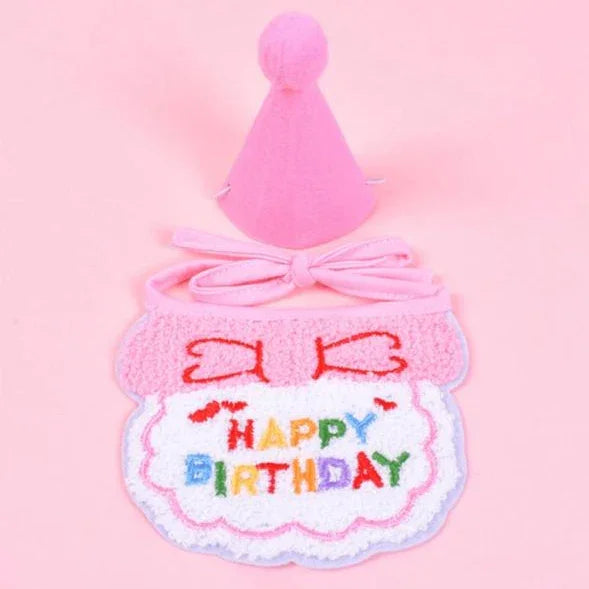 Pink pet birthday hat and bib set with colorful Happy Birthday text on a pink background