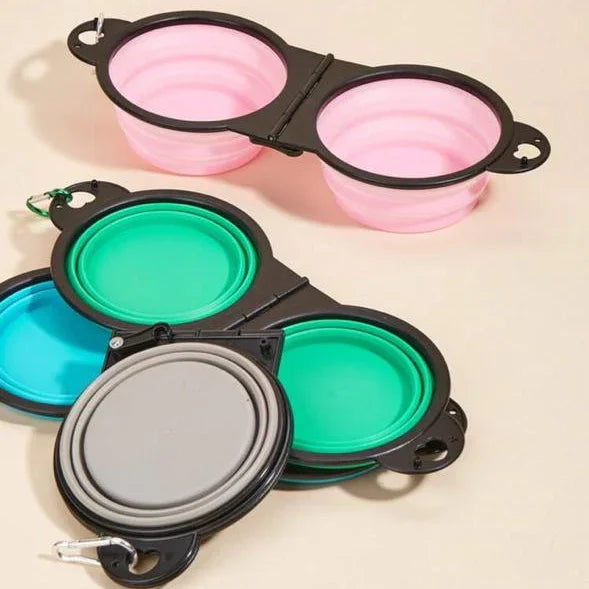 Collapsible silicone travel pet bowls in pink, green, blue, and gray with carabiners.