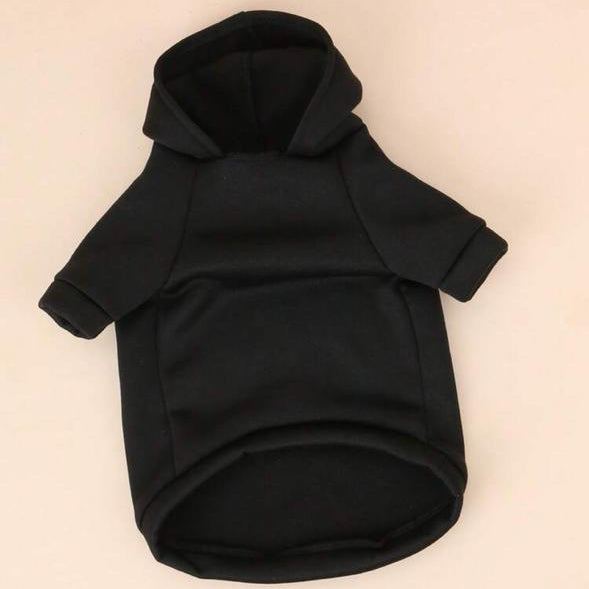 Black pet hoodie with short sleeves, cozy fleece fabric, laid flat on a beige background