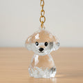 Crystal dog keychain with gold chain on wooden surface, cute pet accessory