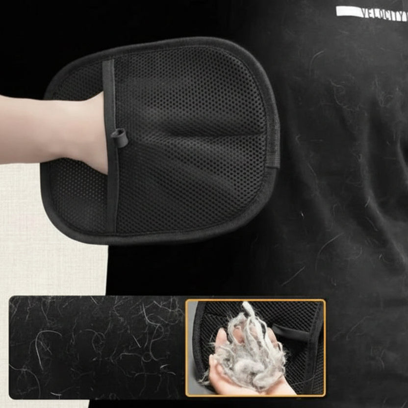 Hand using a black pet hair remover mitt on black fabric with collected pet fur shown