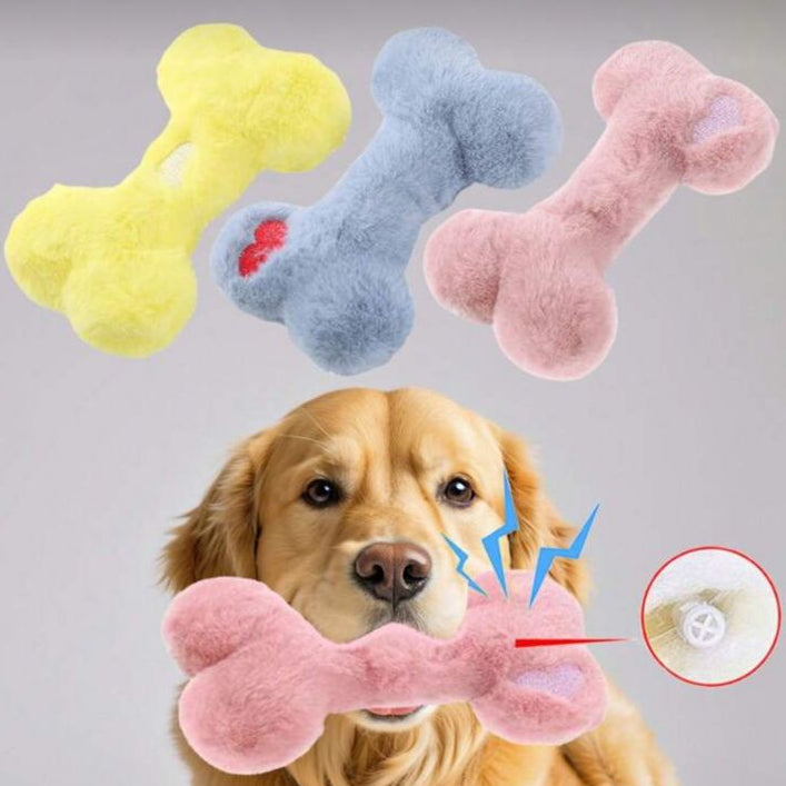 Golden retriever holding a plush bone squeaky toy, with soft toys in pastel colors displayed above.
