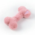 Soft pink plush dog bone toy with heart detail, cute pet accessory on white background