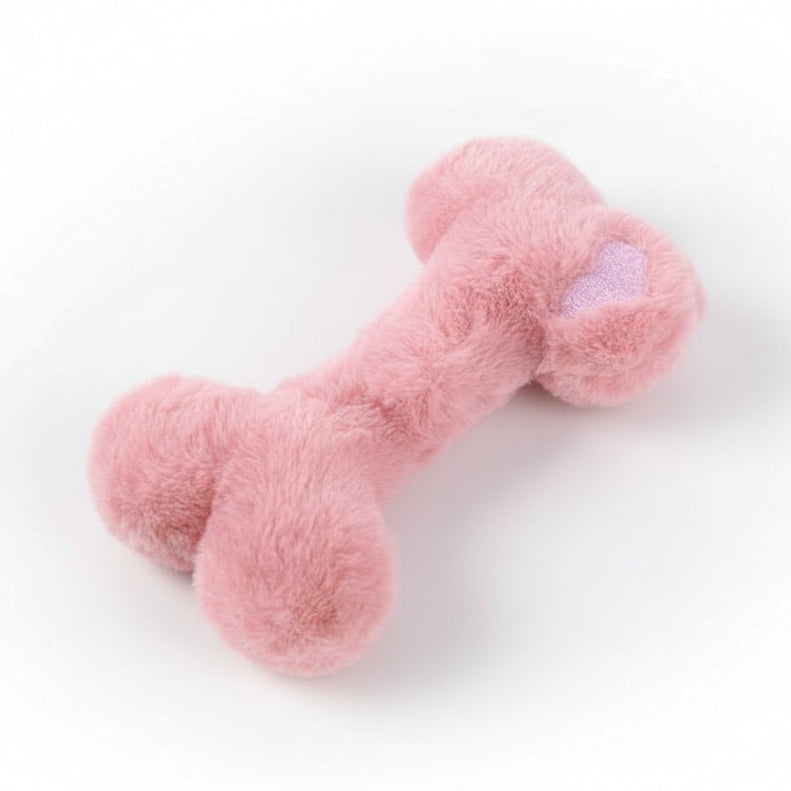 Soft pink plush dog bone toy with heart detail, cute pet accessory on white background
