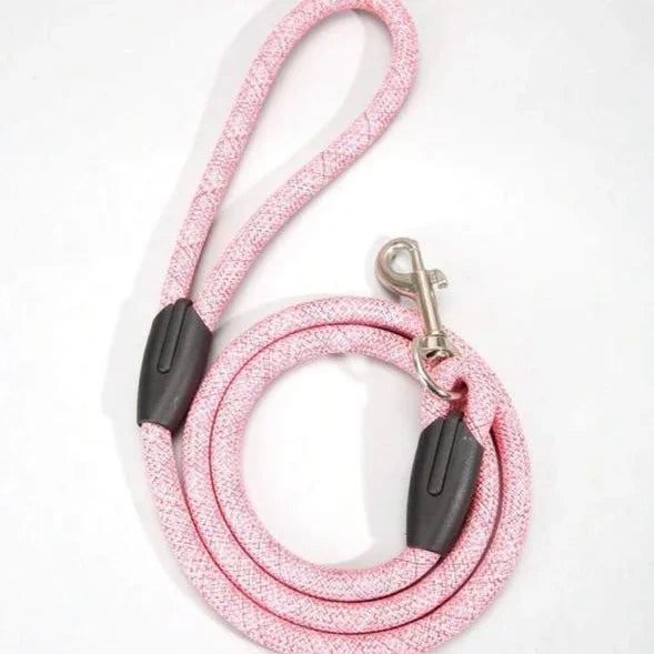 Pink rope dog leash with metal clip and black accents, pet accessory on white background