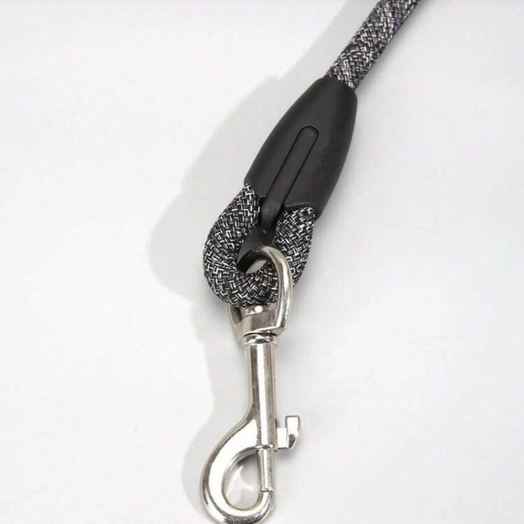 Durable black and white woven dog leash with metal clip for pets on white background