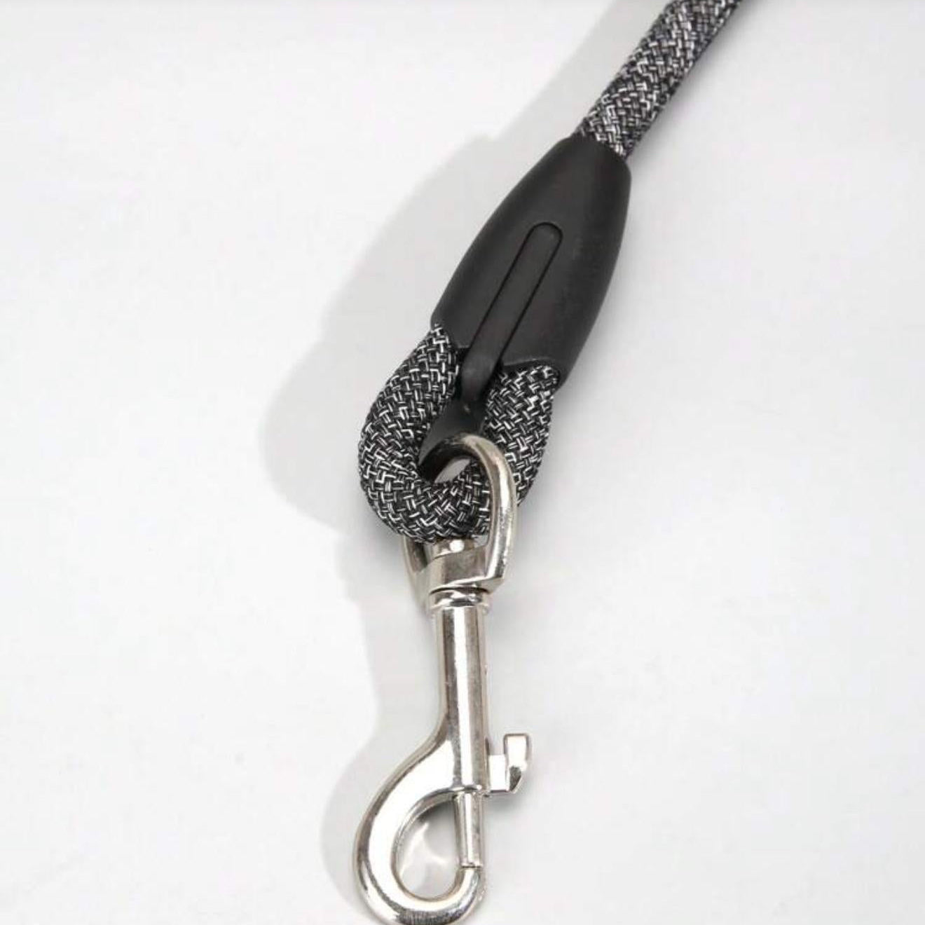 Durable black and white woven dog leash with metal clip for pets on white background