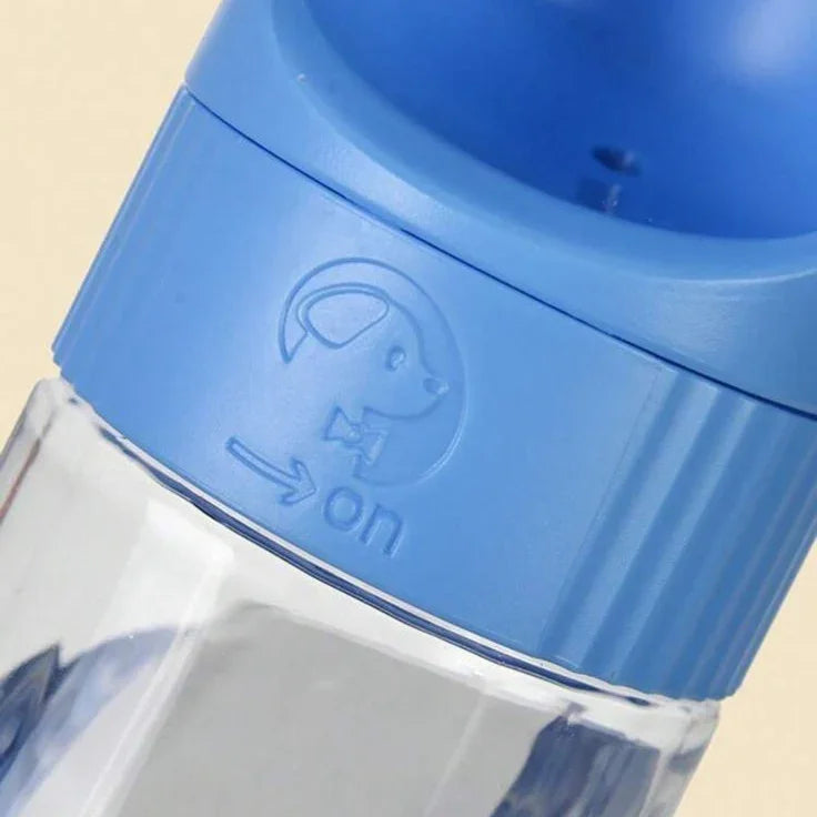 Blue portable dog water bottle with on switch and pet icon, pet accessory close-up
